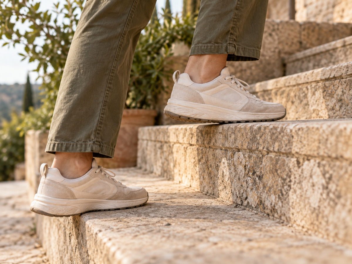 Close-up of a shoe stepping onto an outdoor stone stair